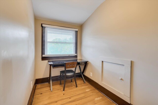 office area featuring light hardwood / wood-style floors and vaulted ceiling