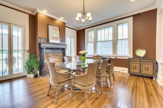 dining space with french doors and crown molding