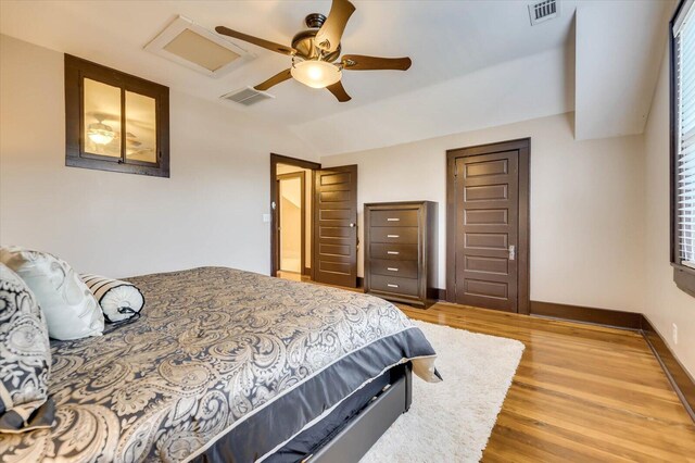 bedroom with hardwood / wood-style floors, ceiling fan, and vaulted ceiling