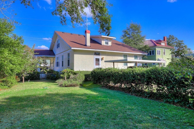 back of house with a yard