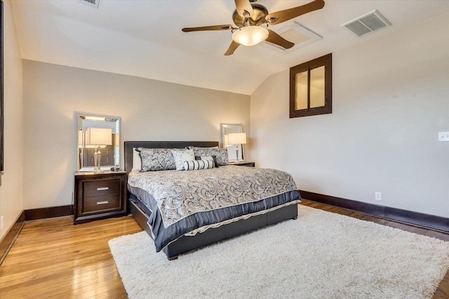 bedroom with ceiling fan, lofted ceiling, and light hardwood / wood-style flooring