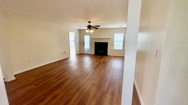 4325 Creekview Dr, Hephzibah, GA 30815 - unfurnished living room featuring healthy amount of natural light, wood finished floors, ceiling fan, and baseboards