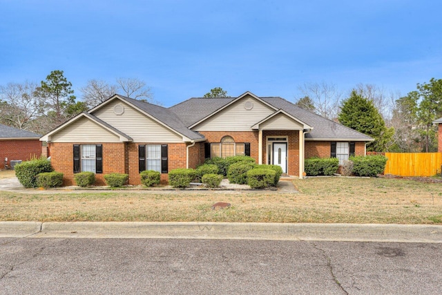 single story home with a front lawn