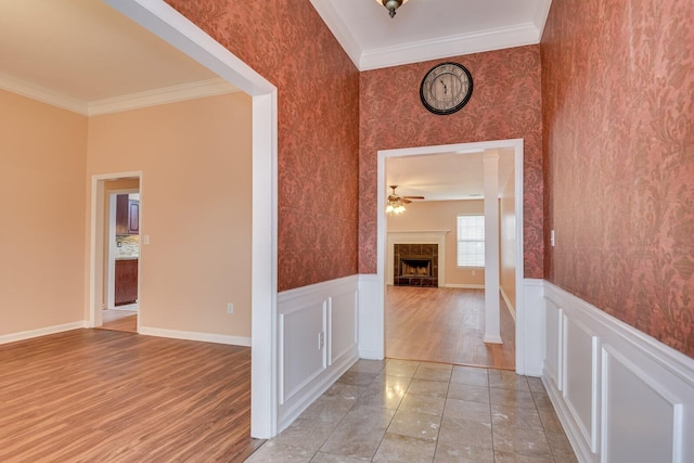 corridor with crown molding and light wood-type flooring