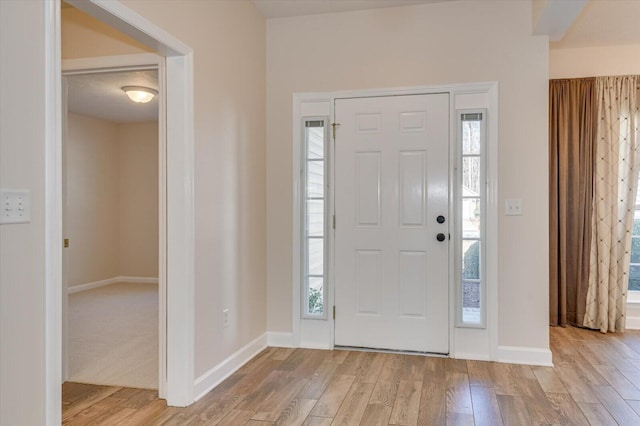 foyer entrance with light wood-type flooring and plenty of natural light