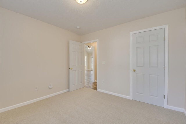 unfurnished bedroom with a textured ceiling and carpet flooring