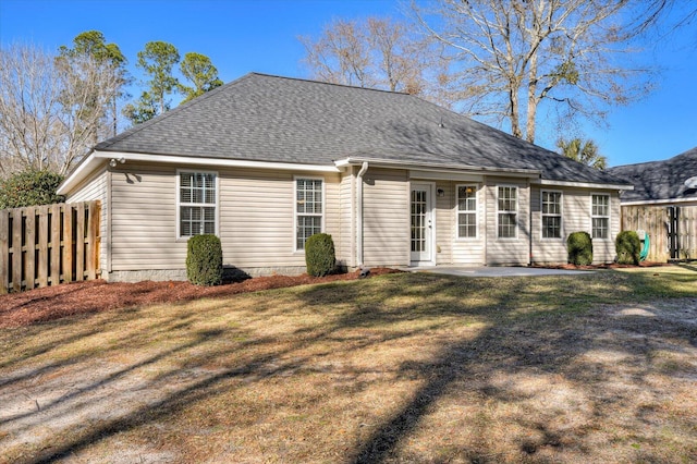 rear view of property with a patio area and a yard