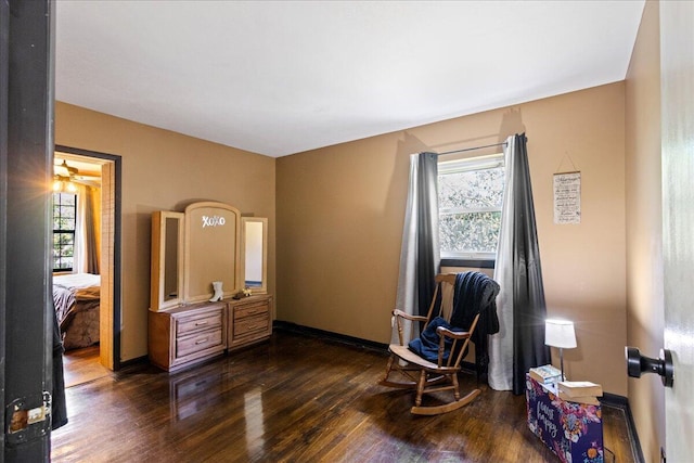 interior space featuring dark wood-style flooring and baseboards