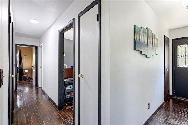 hall with wood-type flooring and baseboards