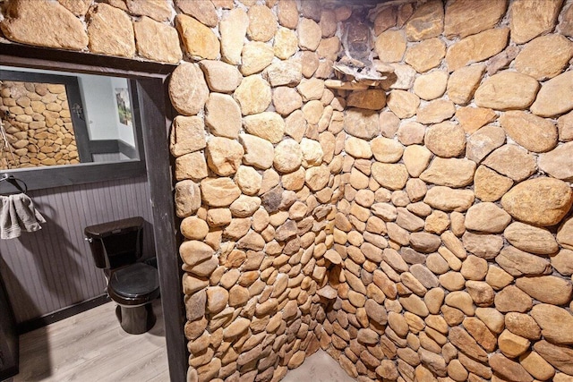 interior space with toilet and wood finished floors