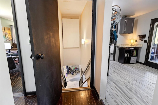 hall featuring baseboards and wood finished floors