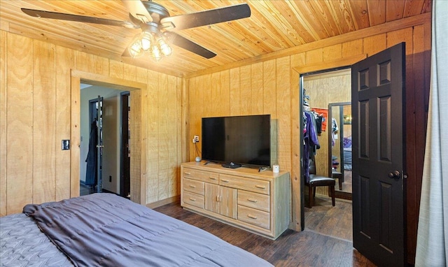 bedroom with wooden walls, dark wood-style flooring, and wooden ceiling