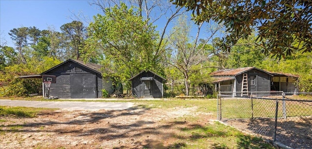 view of yard featuring an outbuilding, fence, and a storage unit