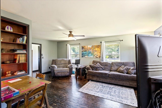 living area featuring wood finished floors, ceiling fan, and a wealth of natural light