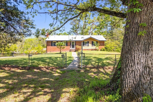 single story home featuring a front yard, brick siding, a gate, and a fenced front yard