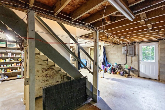 below grade area with electric panel and stairs
