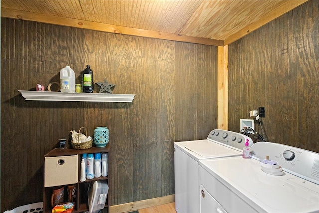 laundry room with wooden walls, independent washer and dryer, wooden ceiling, and laundry area