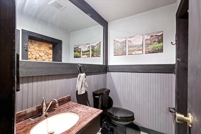 bathroom with visible vents, toilet, and vanity