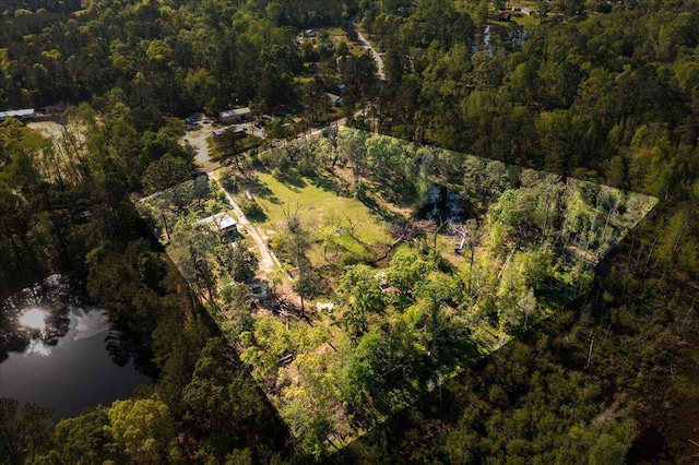 aerial view with a wooded view and a water view