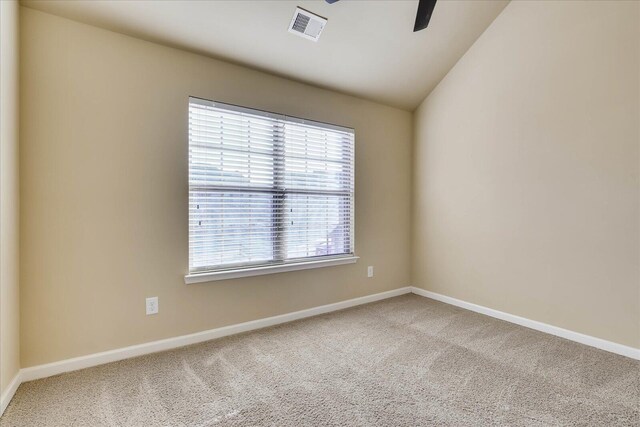 carpeted spare room with ceiling fan and lofted ceiling