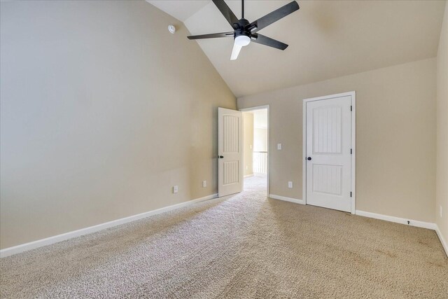 unfurnished bedroom featuring ceiling fan, light carpet, and high vaulted ceiling