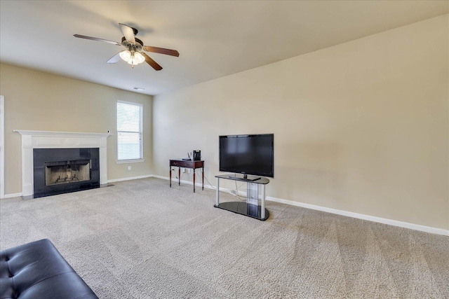 carpeted living room with ceiling fan