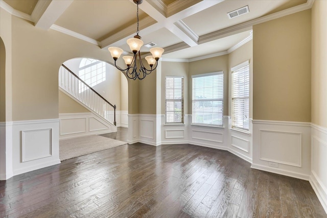 unfurnished dining area with coffered ceiling, crown molding, dark hardwood / wood-style floors, beamed ceiling, and a chandelier