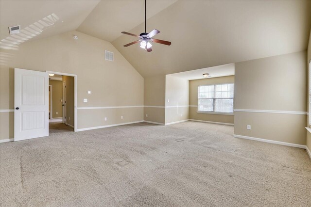 interior space with ceiling fan, lofted ceiling, and light carpet