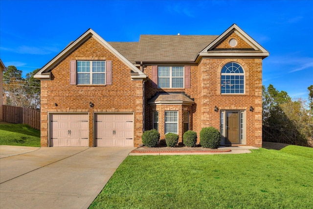 view of front of property featuring a front yard and a garage