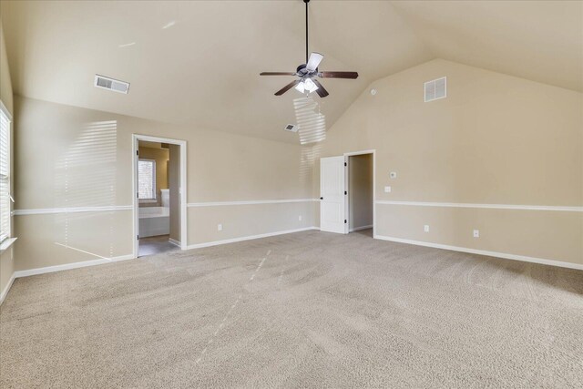 carpeted empty room with ceiling fan and vaulted ceiling