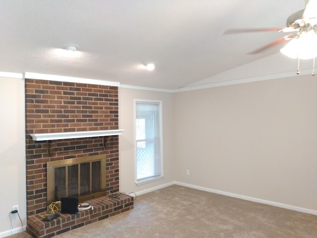 unfurnished living room featuring a fireplace, ornamental molding, carpet floors, and lofted ceiling