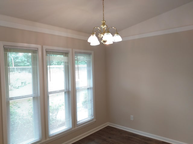 empty room with dark hardwood / wood-style flooring, vaulted ceiling, and an inviting chandelier