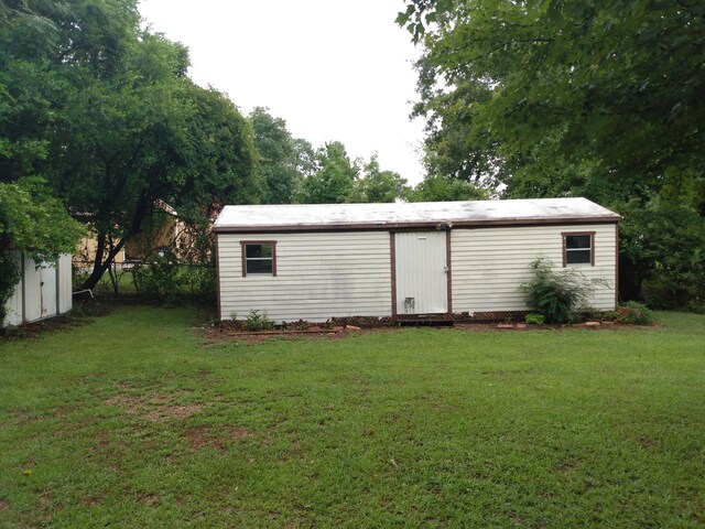 view of outdoor structure featuring a lawn