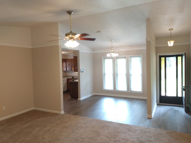 interior space with lofted ceiling, ceiling fan with notable chandelier, and crown molding