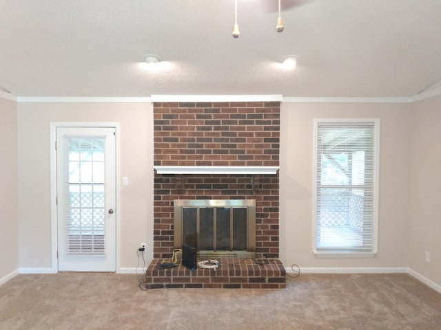 unfurnished living room with carpet flooring, a brick fireplace, and crown molding