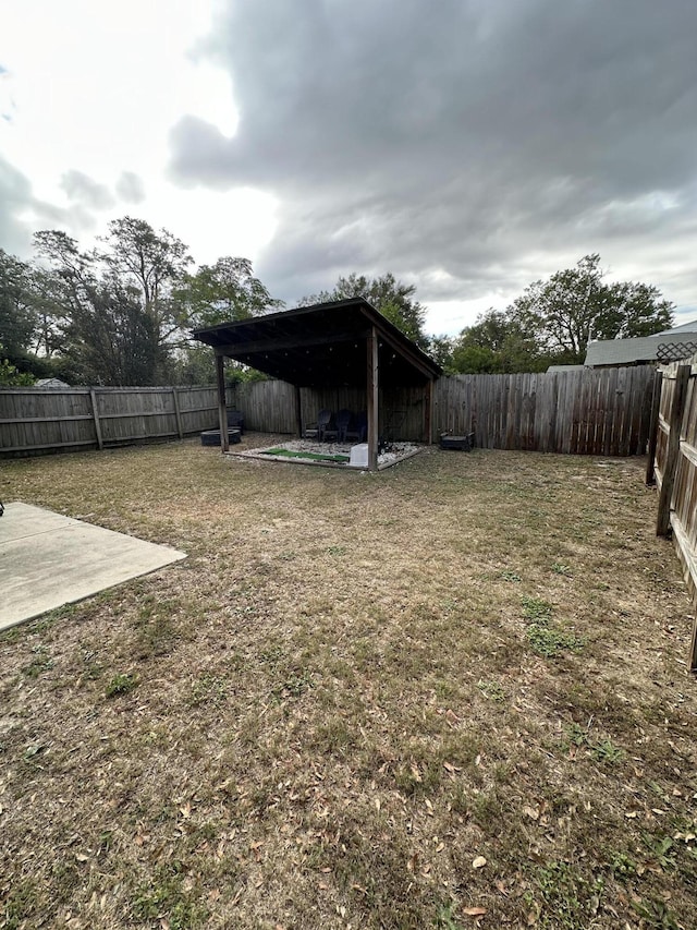 view of yard featuring a patio area and a fenced backyard