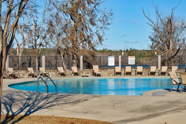 view of swimming pool with a patio