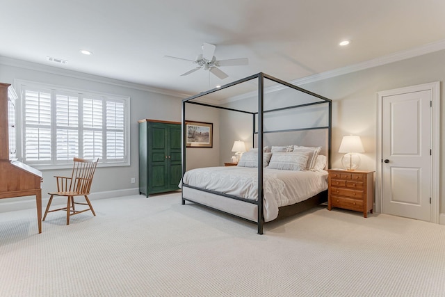 carpeted bedroom with ceiling fan and ornamental molding