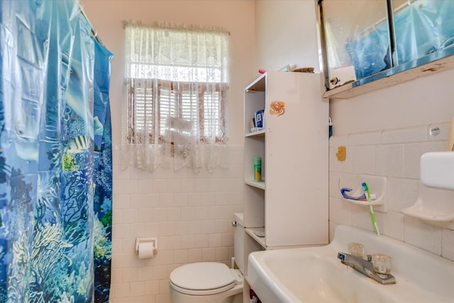 1219 Susan Ct, Waynesboro, GA 30830 - bathroom with tile walls, toilet, a shower with shower curtain, and a sink