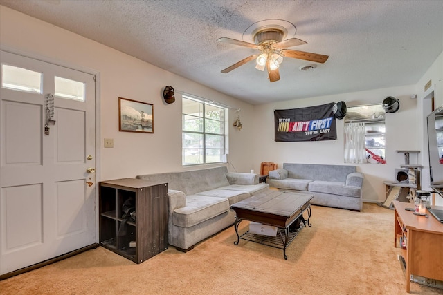 1219 Susan Ct, Waynesboro, GA 30830 - living room featuring a ceiling fan, a textured ceiling, and light colored carpet
