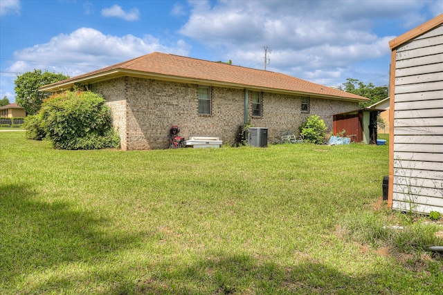 1219 Susan Ct, Waynesboro, GA 30830 - back of property featuring cooling unit, a yard, and brick siding