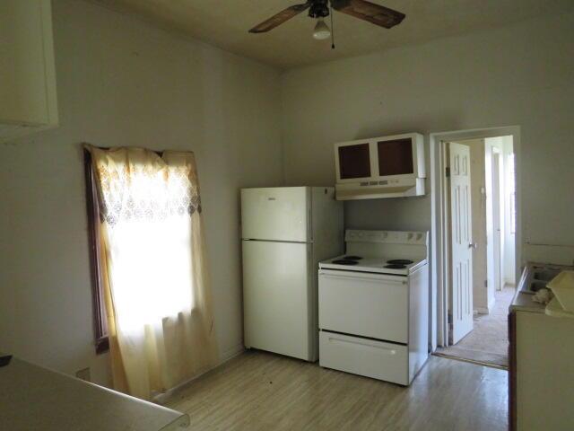 kitchen featuring ceiling fan, under cabinet range hood, white appliances, white cabinetry, and light wood-type flooring