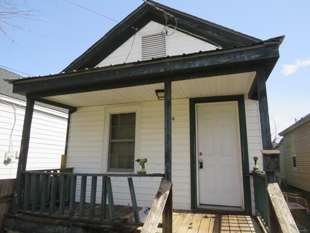 doorway to property featuring covered porch