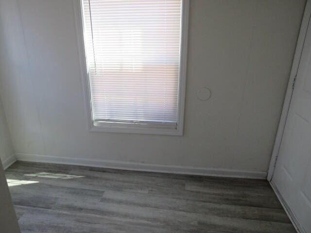 spare room with wood finished floors and baseboards