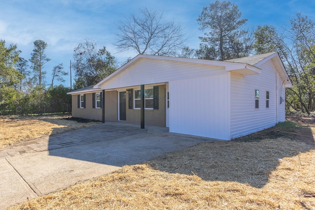 view of front of house with driveway and brick siding