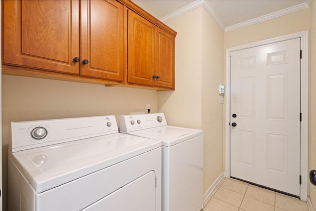 clothes washing area with light tile patterned flooring, cabinets, separate washer and dryer, and ornamental molding