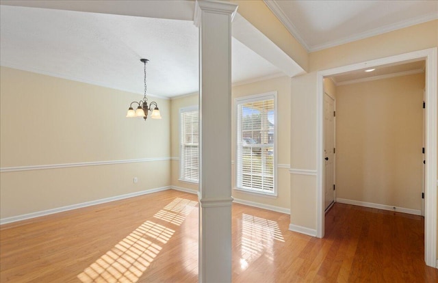 1075 Grove Landing Ln, Grovetown, GA 30813 - interior space with decorative columns, hardwood / wood-style flooring, ornamental molding, and an inviting chandelier