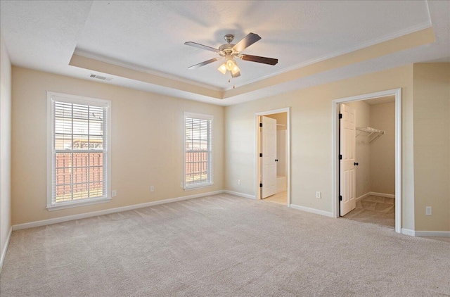 1075 Grove Landing Ln, Grovetown, GA 30813 - unfurnished bedroom with a closet, a walk in closet, a tray ceiling, and ceiling fan