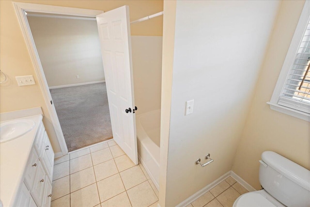 bathroom with tile patterned flooring, vanity, and toilet