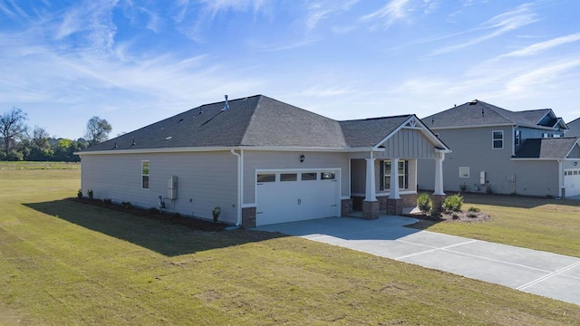 view of front of property with driveway, board and batten siding, a front yard, a shingled roof, and a garage